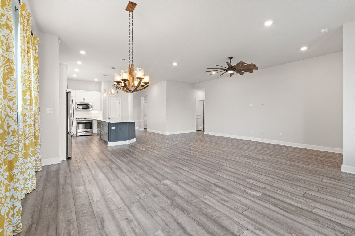 Chandelier, Empty room, Interior, Kitchen, Recessed Lighting, Stainless Steel Appliances, Wood Texture Flooring