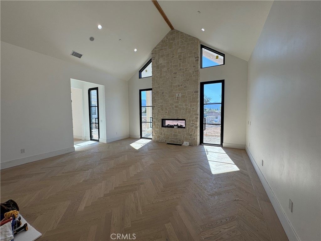 Empty room, Fireplace, Interior, Recessed Lighting, Stone Walls, Wood Texture Flooring