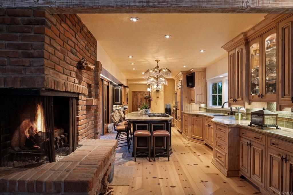 Chandelier, Dining room, Fireplace, Interior, Kitchen, Recessed Lighting, Stone Walls, Wood Texture Flooring