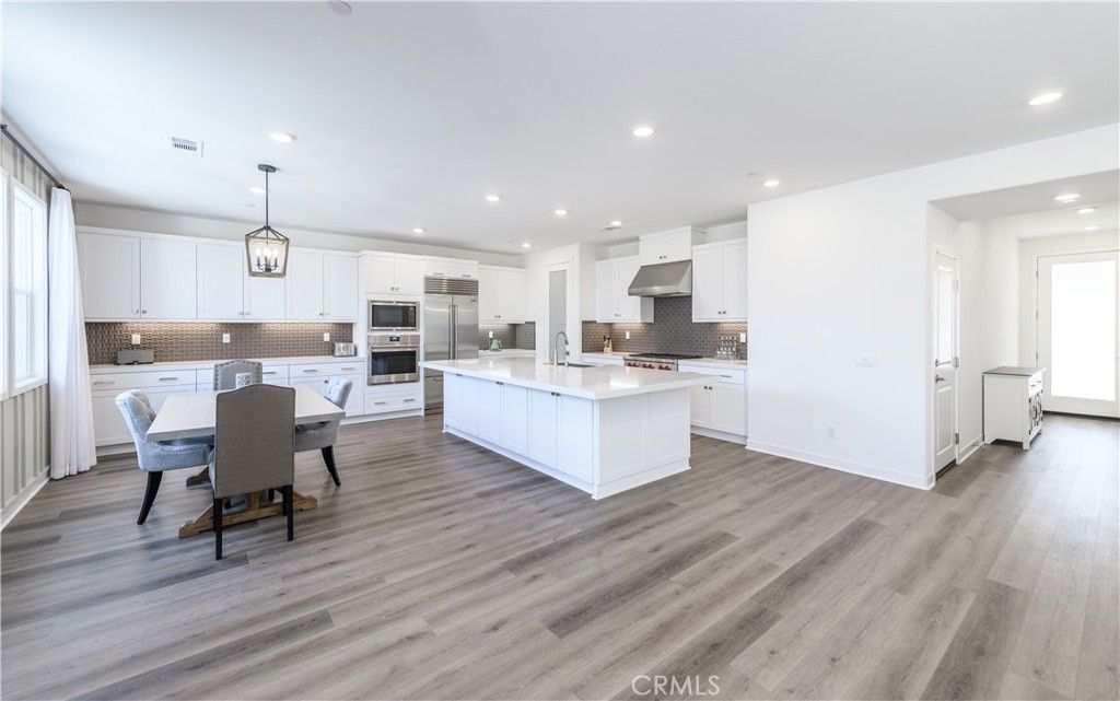 Dining room, Interior, Kitchen, Pendant Lights, Recessed Lighting, Stainless Steel Appliances, Wood Texture Flooring