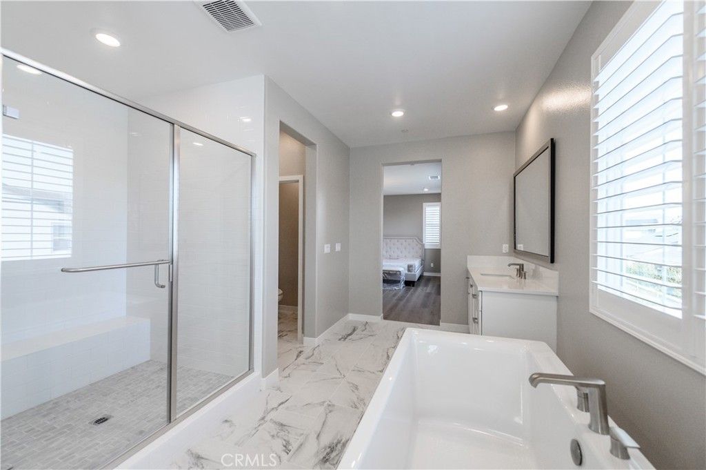 Bathroom, Dual Sink Vanities, Glass Shower, Interior, Marble, Recessed Lighting, Wood Texture Flooring