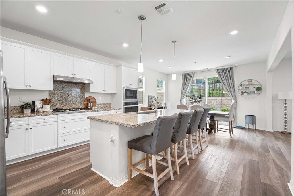 Dining room, Interior, Kitchen, Pendant Lights, Recessed Lighting, Stainless Steel Appliances, Wood Texture Flooring