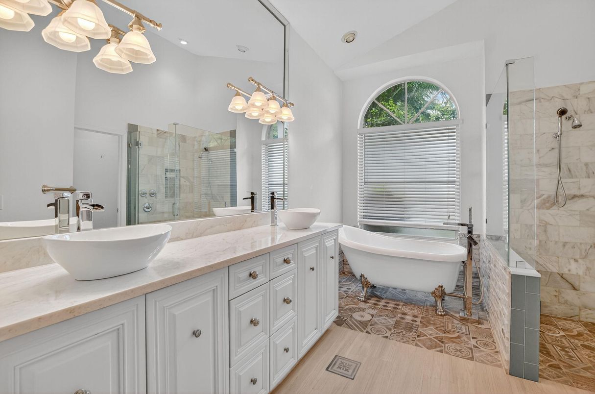 Bathroom, Dual Sink Vanities, Free Standing Baths, Glass Shower, Interior, Marble Walls, Recessed Lighting, Wood Texture Flooring