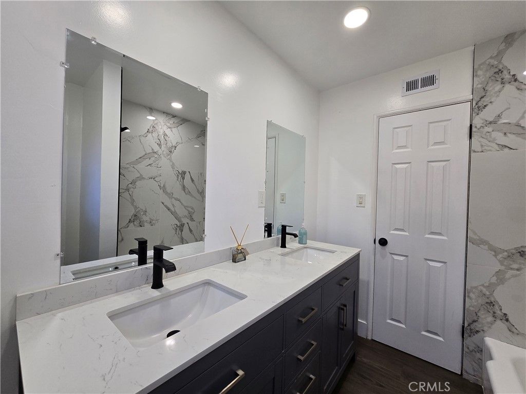 Bathroom, Dual Sink Vanities, Interior, Marble Walls, Recessed Lighting, Wood Texture Flooring