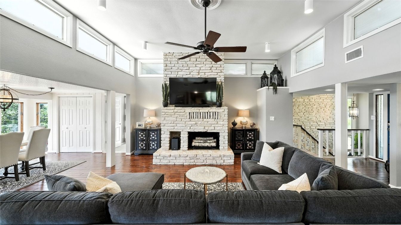 Dining room, Fireplace, Interior, Living room, Recessed Lighting, Stone Walls, Wood Texture Flooring