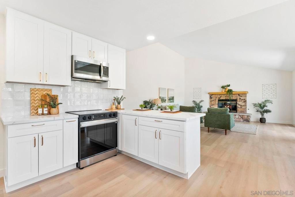 Fireplace, Interior, Kitchen, Living room, Recessed Lighting, Stainless Steel Appliances, Wood Texture Flooring