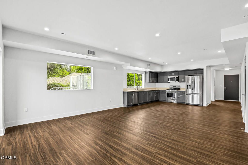 Empty room, Interior, Kitchen, Recessed Lighting, Stainless Steel Appliances, Wood Texture Flooring