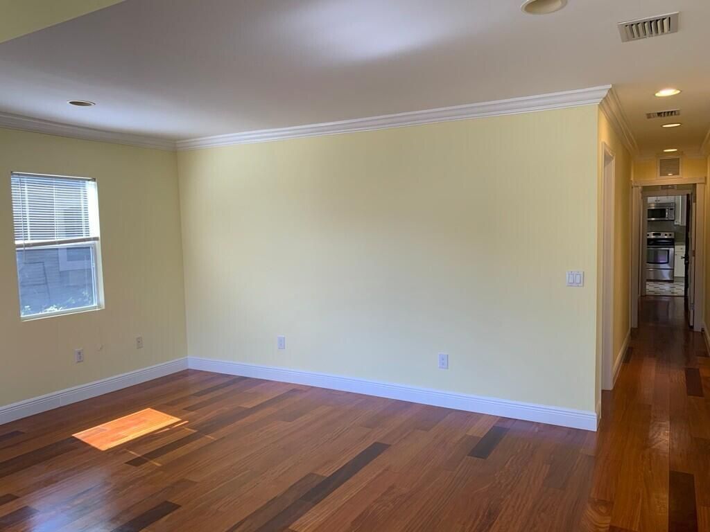 Empty room, Interior, Kitchen, Recessed Lighting, Stainless Steel Appliances, Wood Texture Flooring