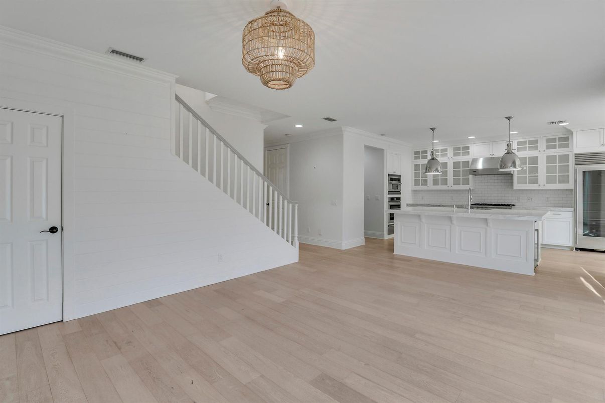 Chandelier, Empty room, Interior, Kitchen, Pendant Lights, Recessed Lighting, Stainless Steel Appliances, Wood Texture Flooring