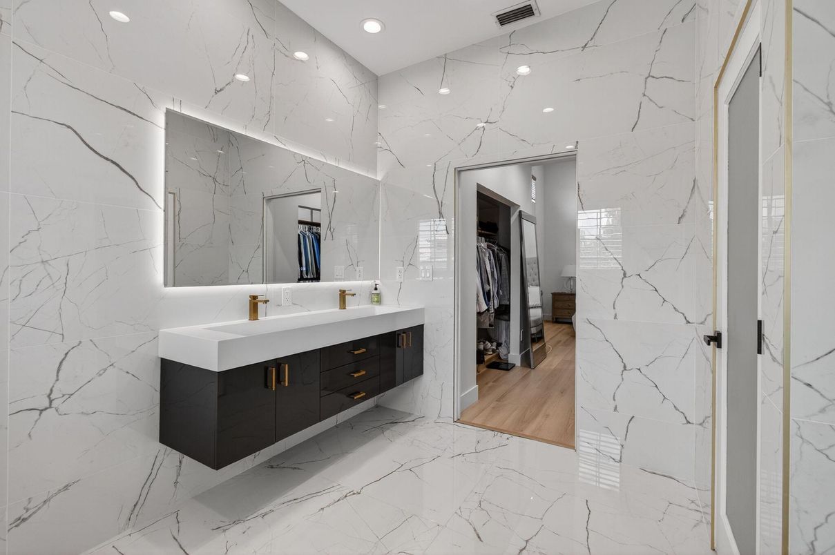 Bathroom, Dual Sink Vanities, Interior, Marble, Marble Walls, Recessed Lighting, Wood Texture Flooring
