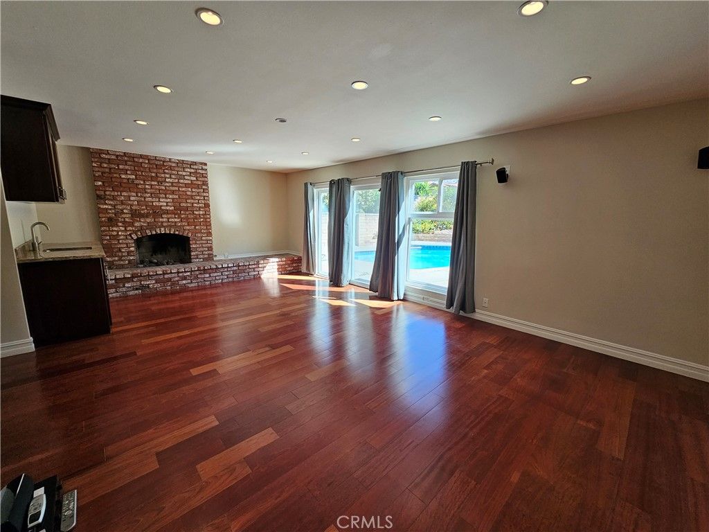 Empty room, Fireplace, Interior, Recessed Lighting, Stone Walls, Wood Texture Flooring