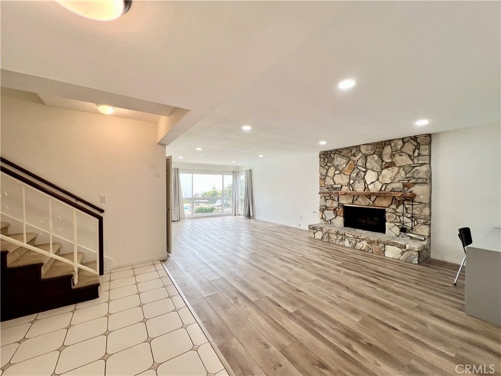 Empty room, Fireplace, Interior, Recessed Lighting, Stone Walls, Wood Texture Flooring