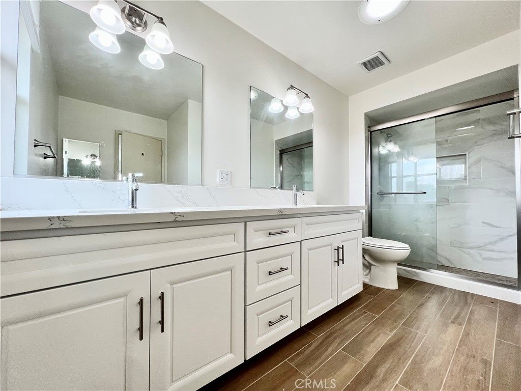 Bathroom, Dual Sink Vanities, Glass Shower, Interior, Marble Walls, Wood Texture Flooring
