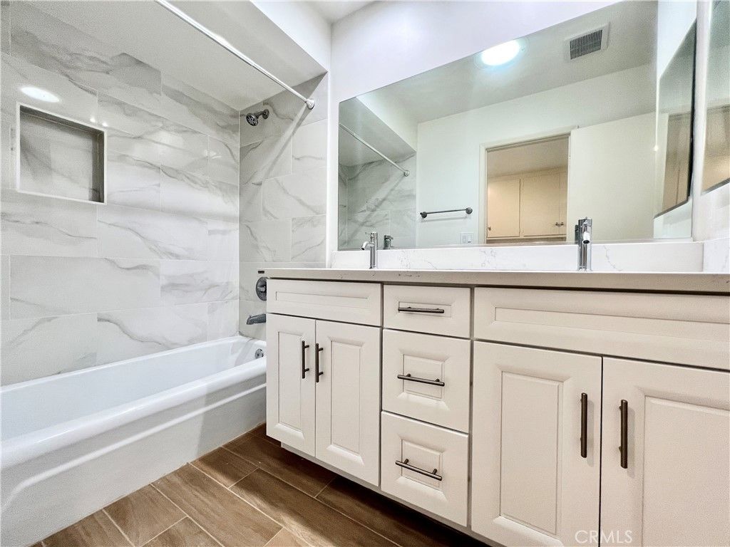 Bathroom, Dual Sink Vanities, Interior, Marble Walls, Recessed Lighting, Wood Texture Flooring