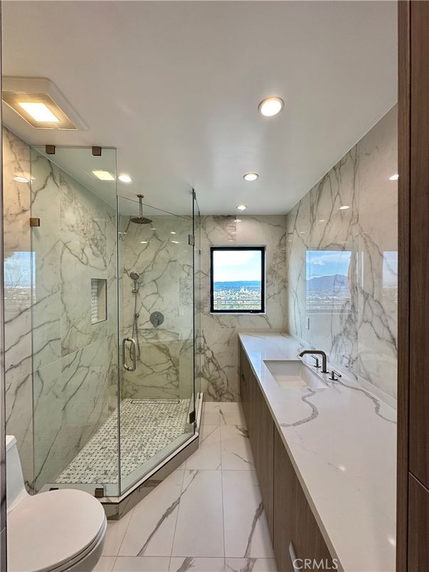 Bathroom, Dual Sink Vanities, Glass Shower, Interior, Marble, Marble Walls, Recessed Lighting