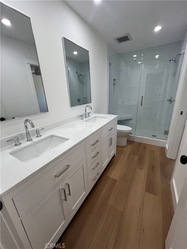 Bathroom, Dual Sink Vanities, Glass Shower, Interior, Recessed Lighting, Wood Texture Flooring