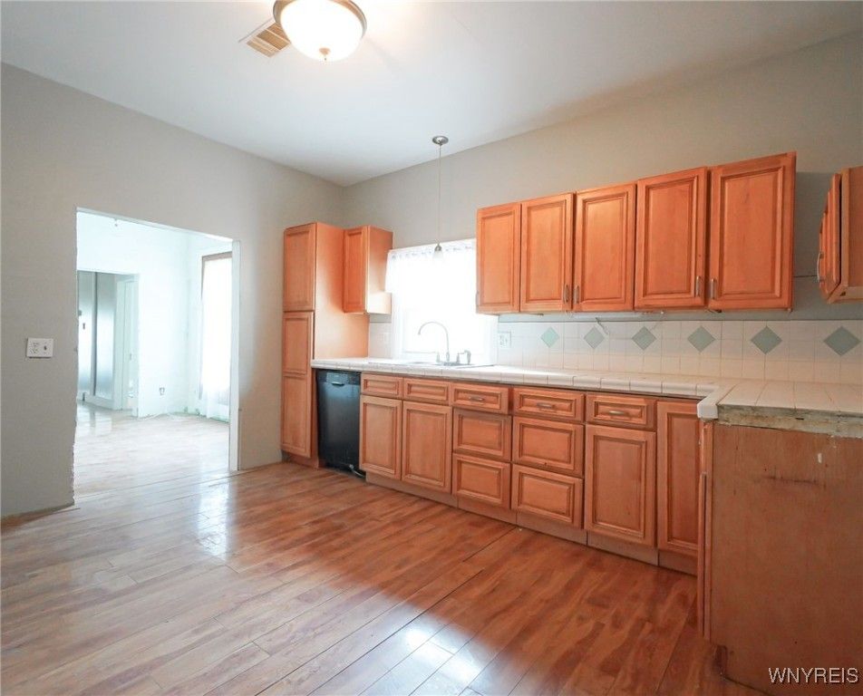 Interior, Kitchen, Pendant Lights, Tile Countertops, Wood Texture Flooring