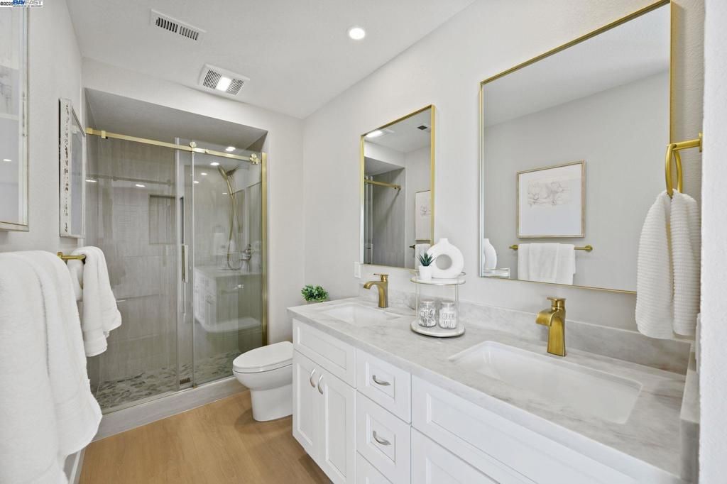 Bathroom, Dual Sink Vanities, Glass Shower, Interior, Recessed Lighting, Wood Texture Flooring