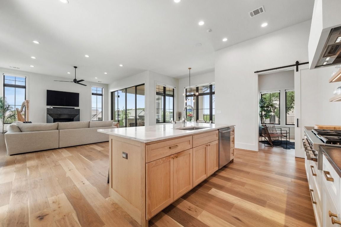 Dining room, Fireplace, Interior, Kitchen, Living room, Pendant Lights, Recessed Lighting, Stainless Steel Appliances, Wood Texture Flooring