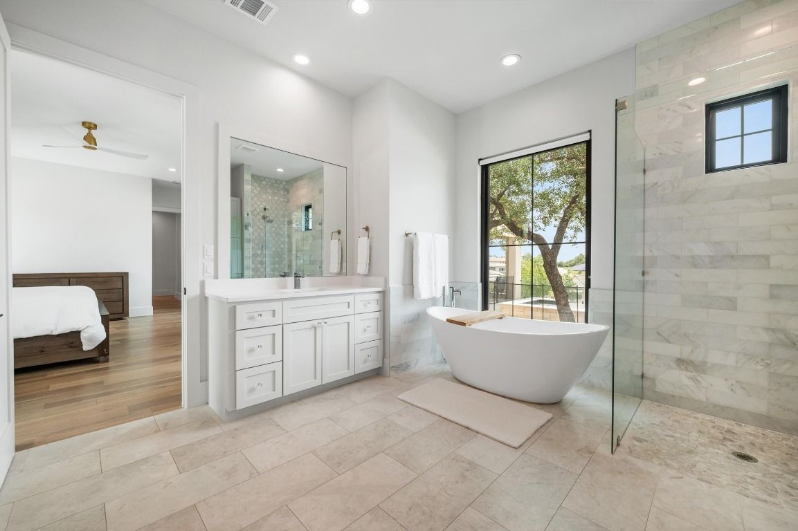 Bathroom, Bedroom, Dual Sink Vanities, Free Standing Baths, Glass Shower, Interior, Marble Walls, Recessed Lighting, Wood Texture Flooring