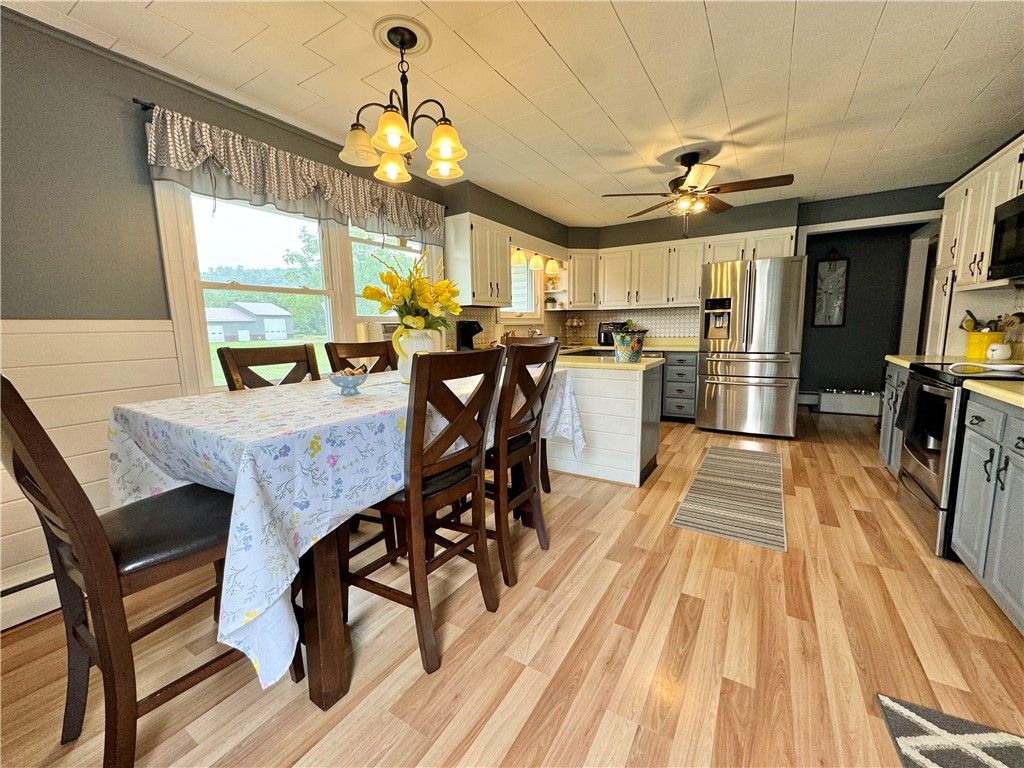 Chandelier, Dining room, Interior, Kitchen, Stainless Steel Appliances, Wood Texture Flooring