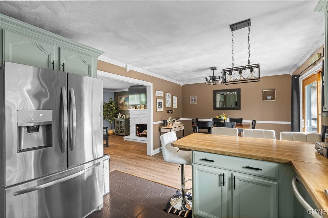 Dining room, Fireplace, Interior, Kitchen, Pendant Lights, Stainless Steel Appliances, Wood Texture Flooring