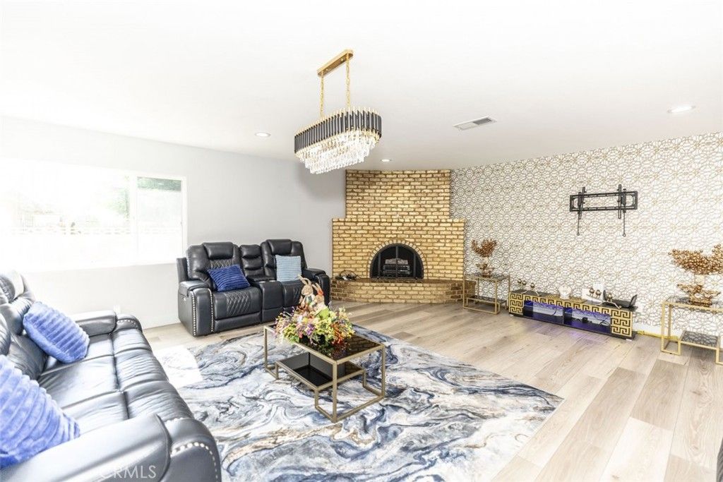 Chandelier, Fireplace, Interior, Living room, Recessed Lighting, Stone Walls, Wood Texture Flooring