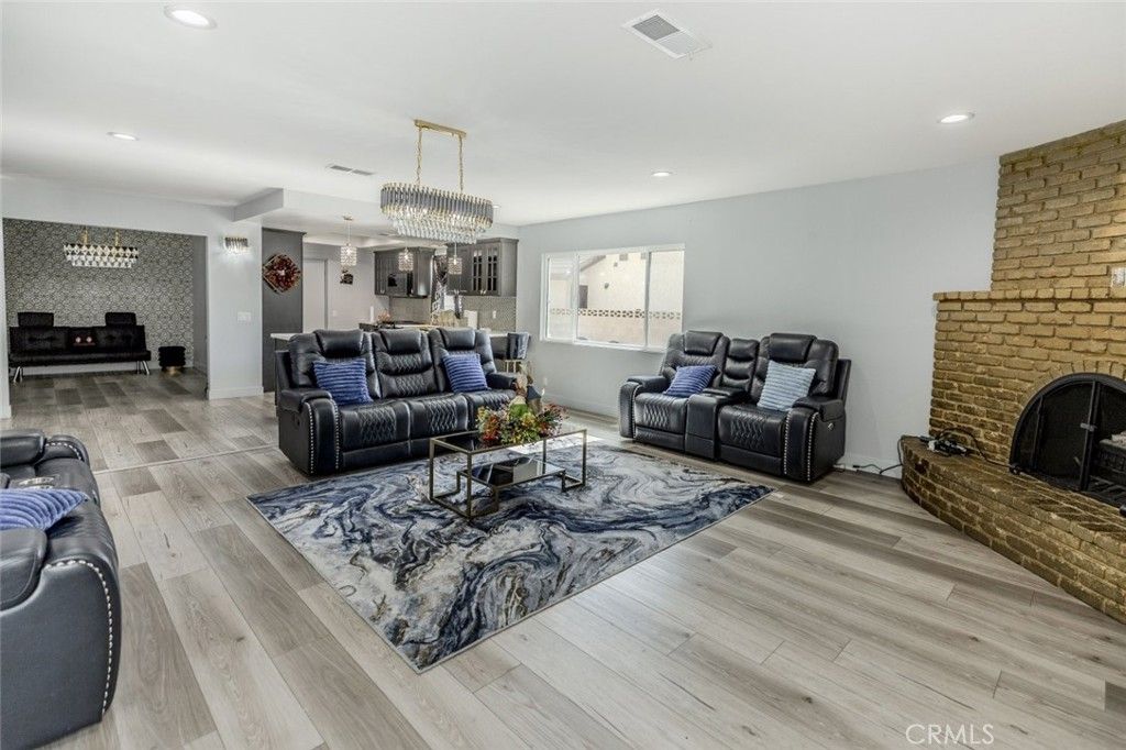 Chandelier, Fireplace, Interior, Living room, Pendant Lights, Recessed Lighting, Stone Walls, Wood Texture Flooring