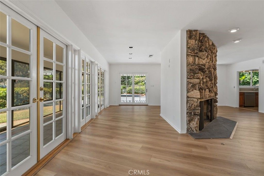 Empty room, Fireplace, Interior, Recessed Lighting, Stone Walls, Wood Texture Flooring