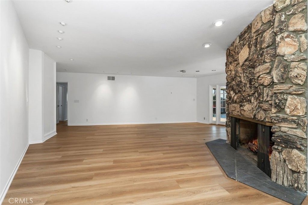 Empty room, Fireplace, Interior, Recessed Lighting, Stone Walls, Wood Texture Flooring