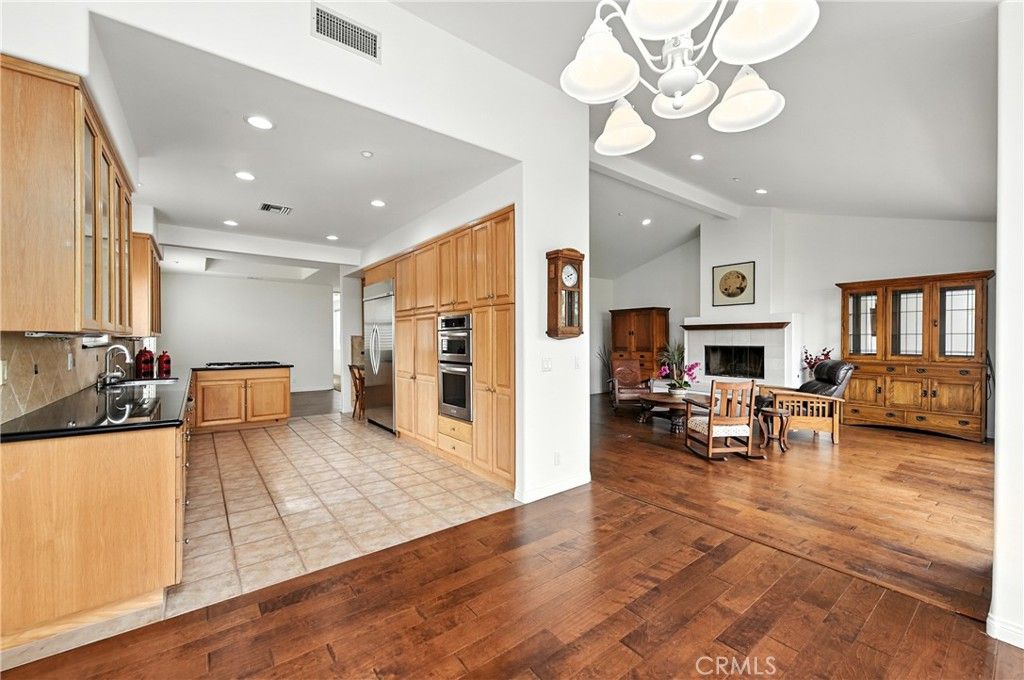 Dining room, Fireplace, Interior, Kitchen, Living room, Recessed Lighting, Stainless Steel Appliances, Wood Texture Flooring