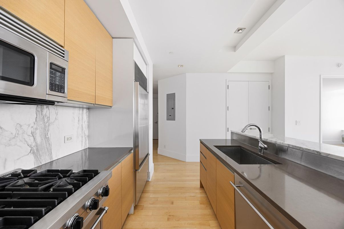 Interior, Kitchen, Marble Walls, Recessed Lighting, Stainless Steel Appliances, Wood Texture Flooring