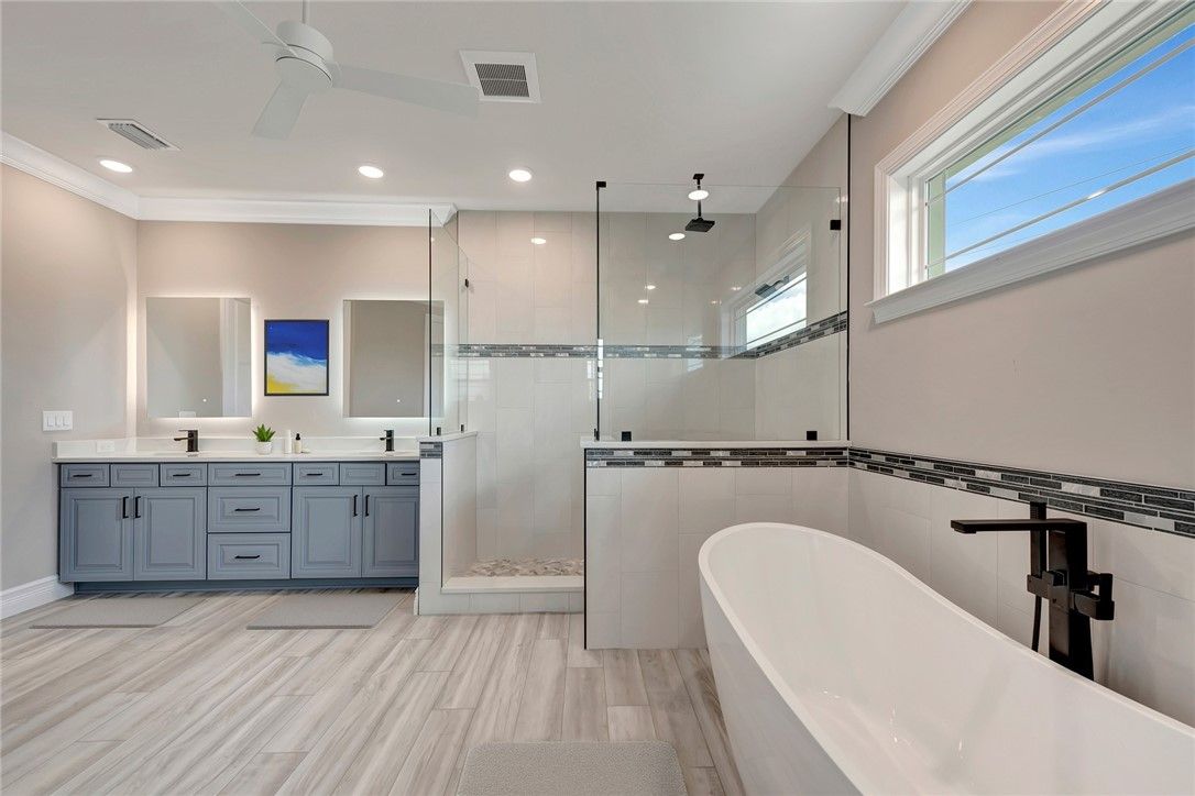 Bathroom, Dual Sink Vanities, Free Standing Baths, Glass Shower, Interior, Recessed Lighting, Wood Texture Flooring