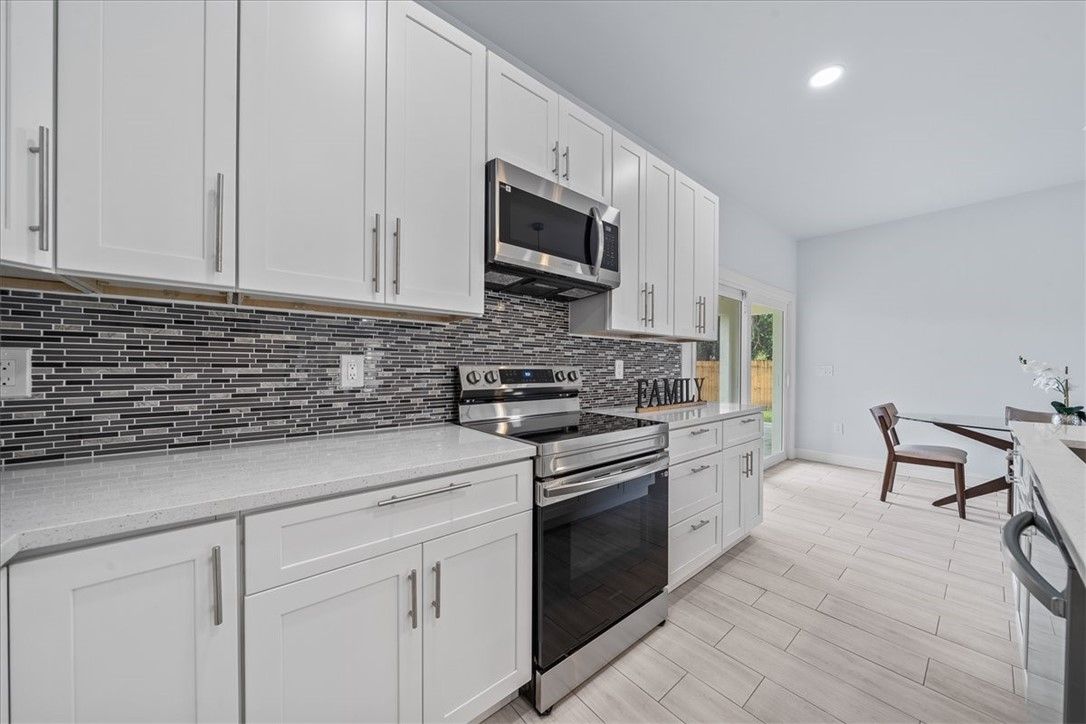 Dining room, Interior, Kitchen, Recessed Lighting, Stainless Steel Appliances, Wood Texture Flooring
