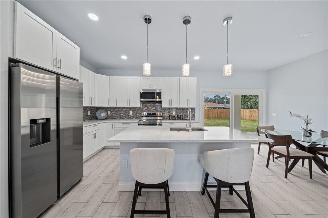 Dining room, Interior, Kitchen, Pendant Lights, Recessed Lighting, Stainless Steel Appliances, Wood Texture Flooring