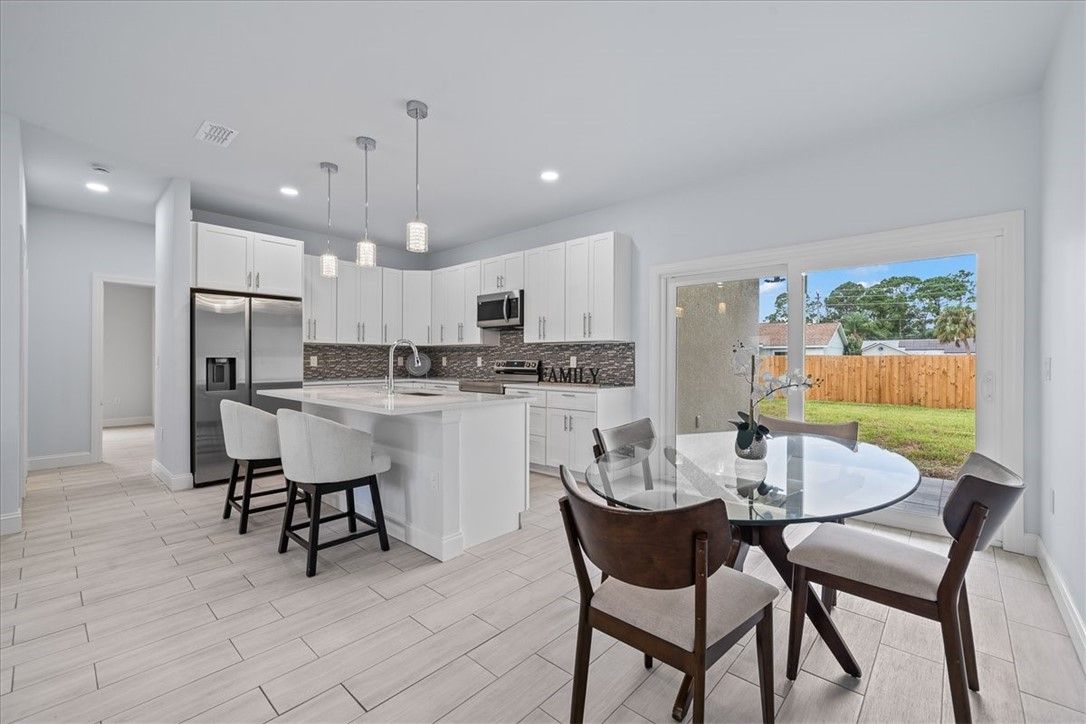 Dining room, Interior, Kitchen, Pendant Lights, Recessed Lighting, Stainless Steel Appliances, Wood Texture Flooring
