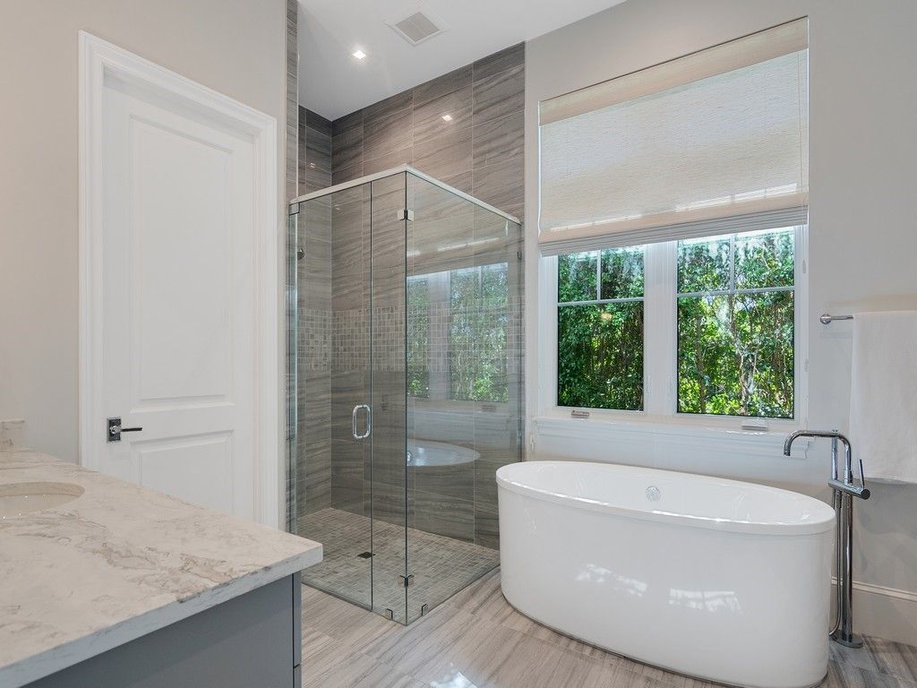 Bathroom, Free Standing Baths, Glass Shower, Interior, Marble Walls, Recessed Lighting, Wood Texture Flooring