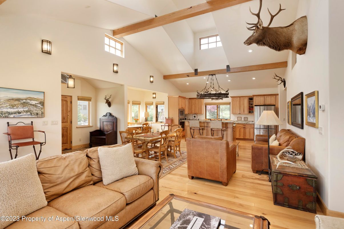 Chandelier, Dining room, Interior, Kitchen, Living room, Pendant Lights, Recessed Lighting, Stainless Steel Appliances, Wooden Beams, Wood Texture Flooring
