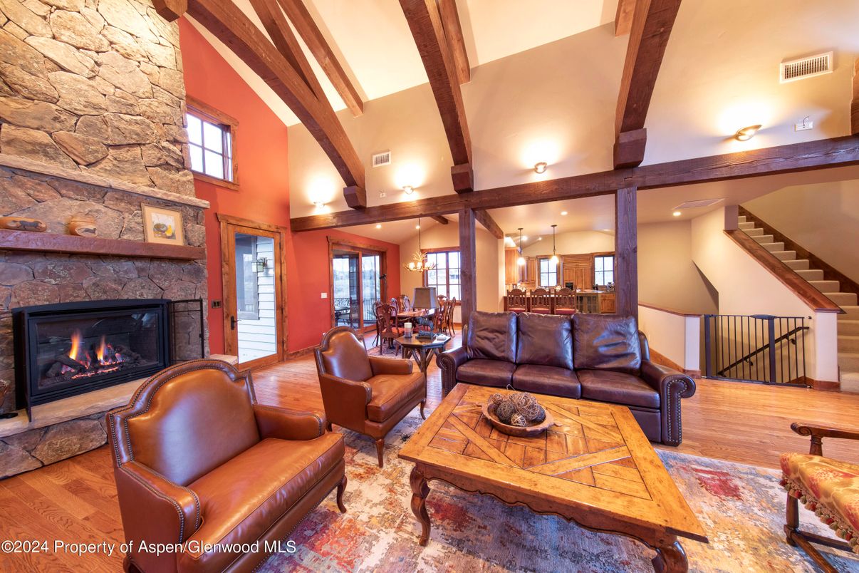 Dining room, Fireplace, Interior, Living room, Pendant Lights, Recessed Lighting, Stone Walls, Wooden Beams, Wood Texture Flooring