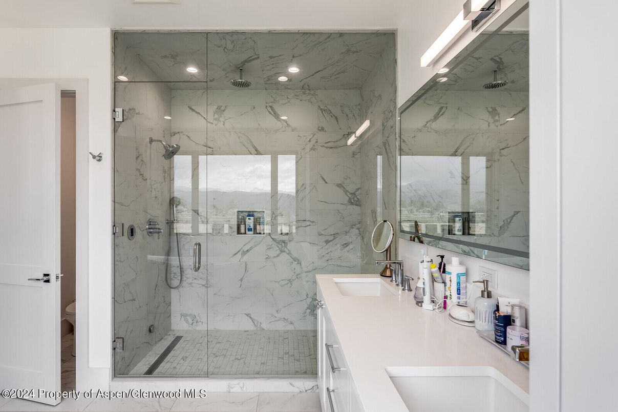 Bathroom, Dual Sink Vanities, Glass Shower, Interior, Marble, Marble Walls, Recessed Lighting