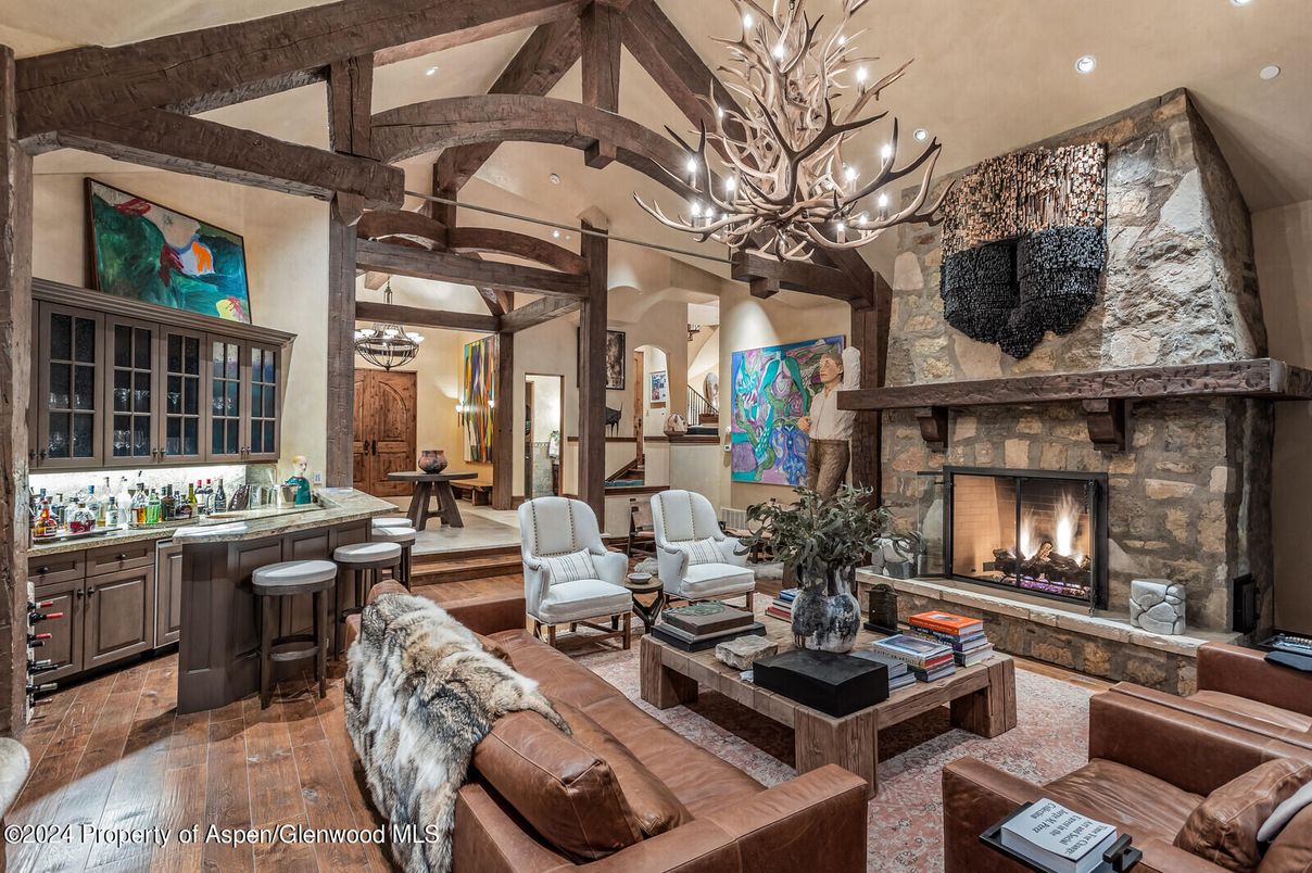 Chandelier, Fireplace, Interior, Living room, Recessed Lighting, Stone Walls, Wooden Beams, Wood Texture Flooring