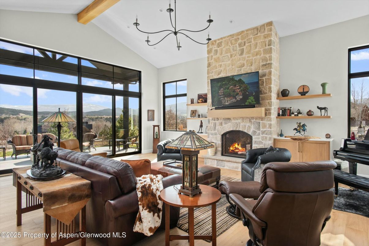 Chandelier, Fireplace, Interior, Living room, Piano, Stone Walls, Wooden Beams, Wood Texture Flooring