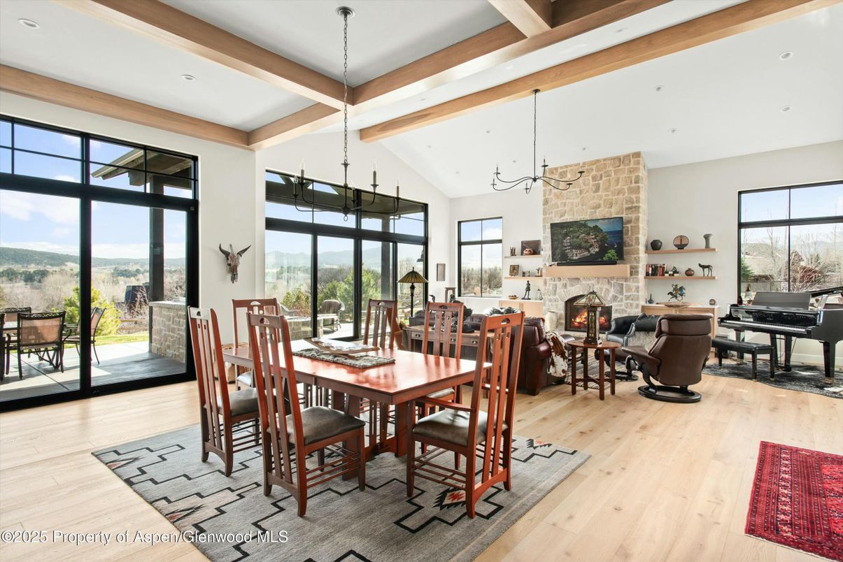 Dining room, Fireplace, Interior, Living room, Pendant Lights, Piano, Recessed Lighting, Stone Walls, Wooden Beams, Wood Texture Flooring