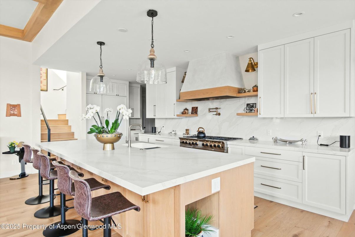 Interior, Kitchen, Marble Walls, Pendant Lights, Recessed Lighting, Stainless Steel Appliances, Wood Texture Flooring