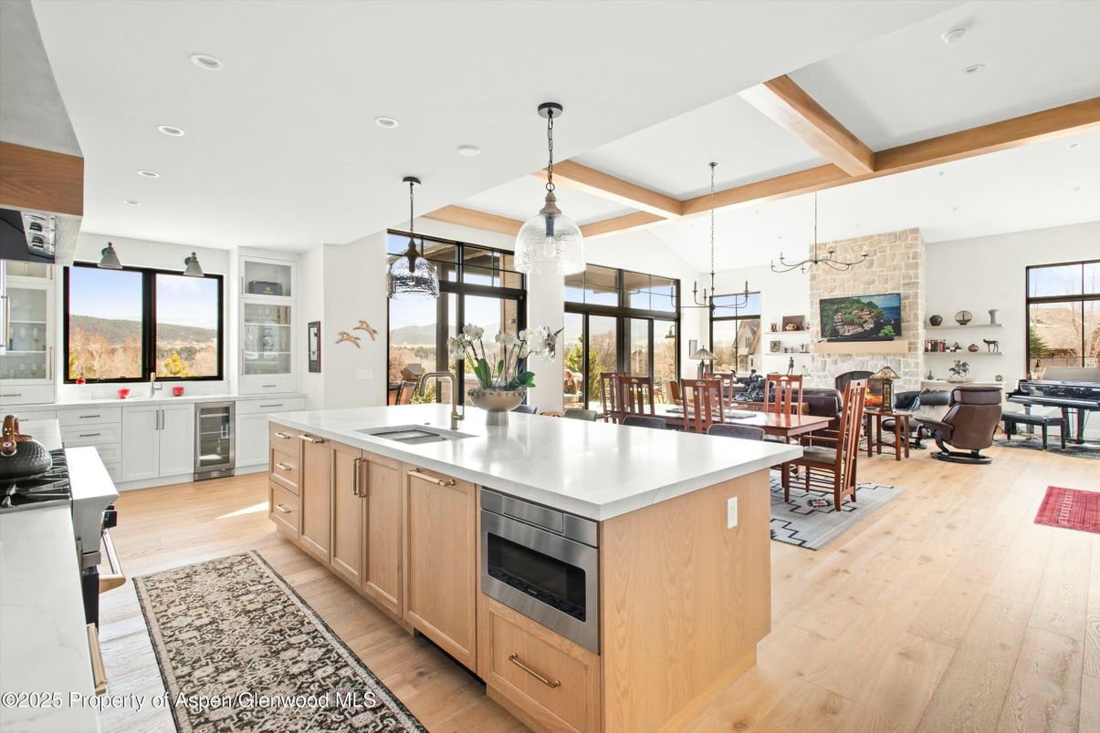 Dining room, Fireplace, Interior, Kitchen, Living room, Pendant Lights, Recessed Lighting, Stainless Steel Appliances, Stone Walls, Wooden Beams, Wood Texture Flooring