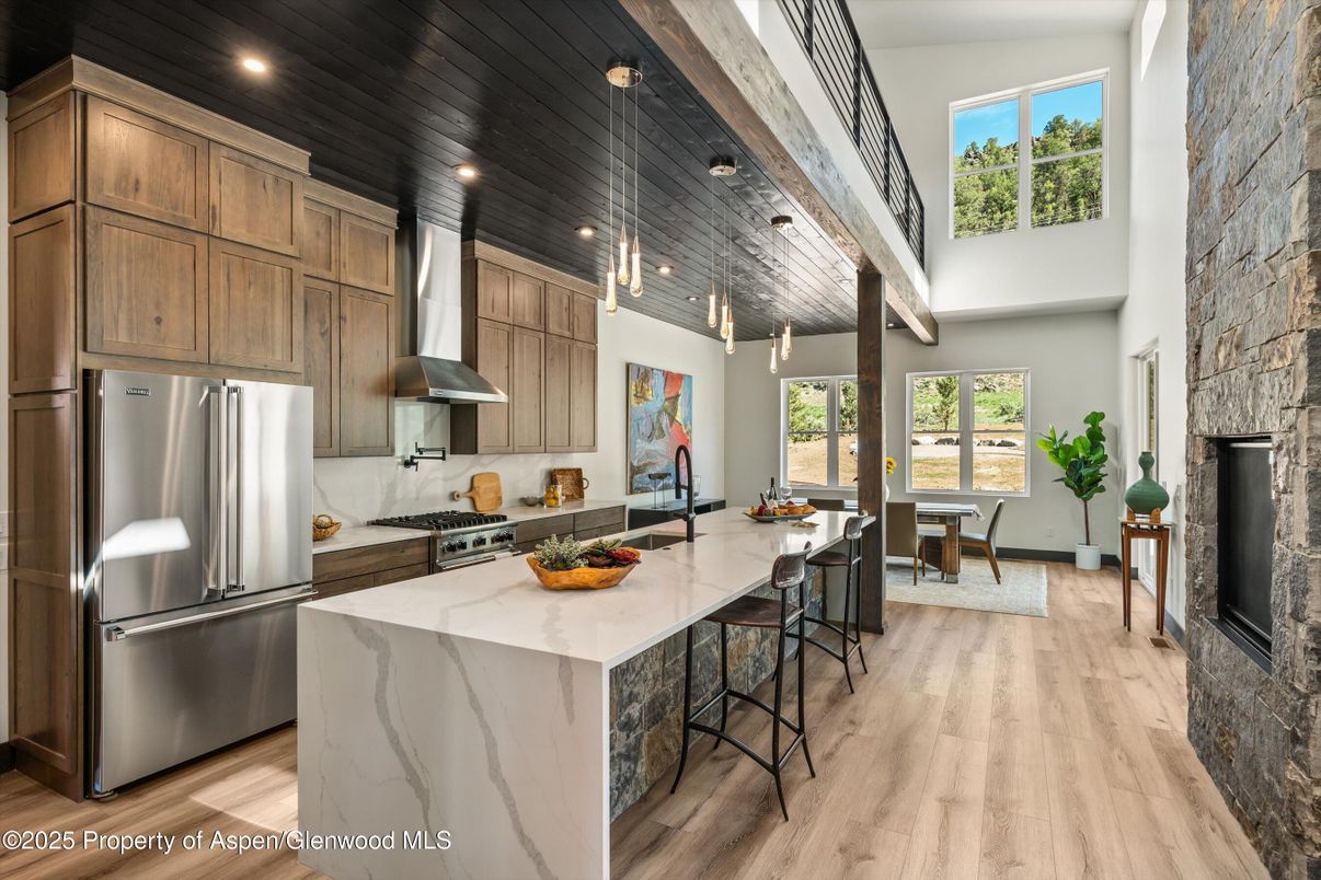 Dining room, Fireplace, Interior, Kitchen, Pendant Lights, Recessed Lighting, Stainless Steel Appliances, Wood Texture Flooring