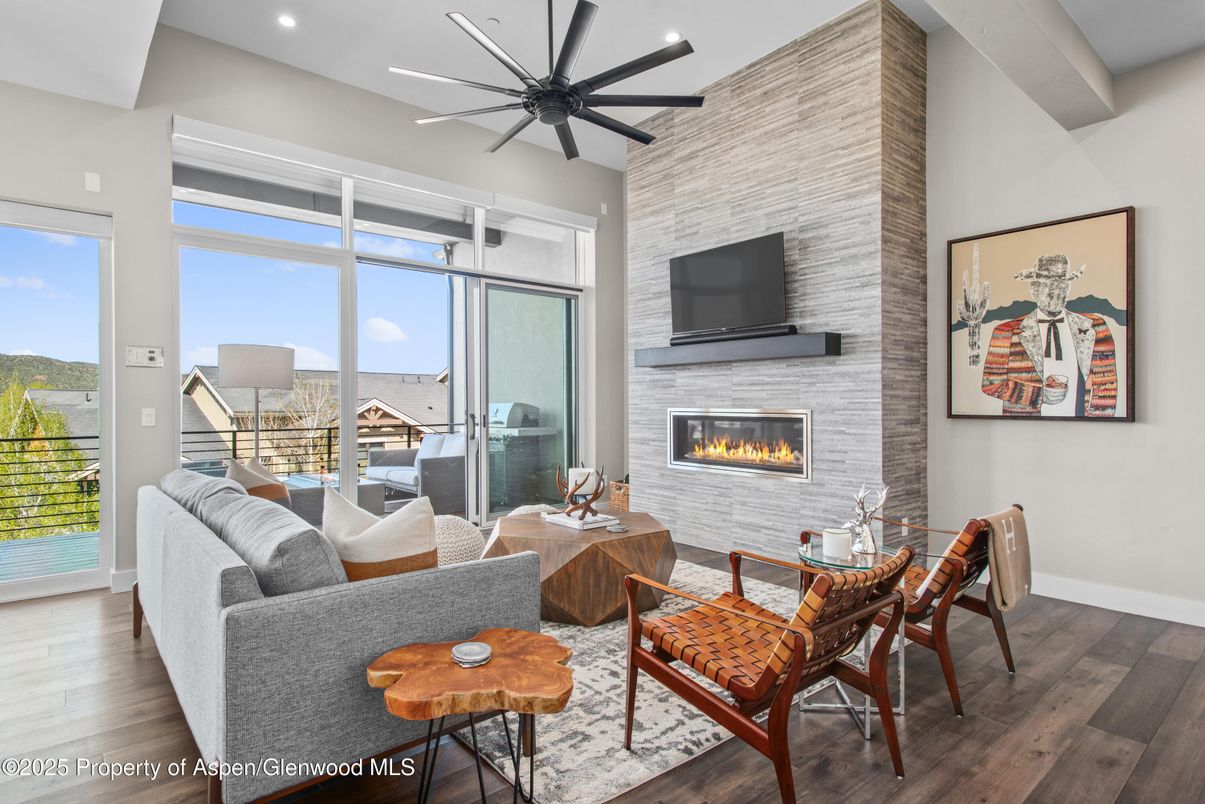 Dining room, Fireplace, Interior, Living room, Recessed Lighting, Stone Walls, Wood Texture Flooring