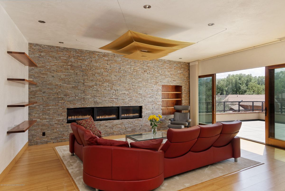 Fireplace, Interior, Living room, Recessed Lighting, Stone Walls, Wood Texture Flooring