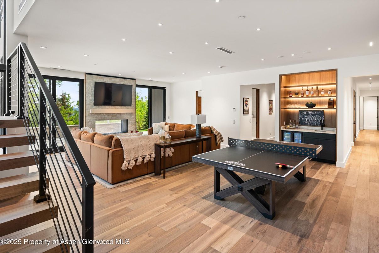 Fireplace, Game Room, Interior, Living room, Recessed Lighting, Wood Texture Flooring