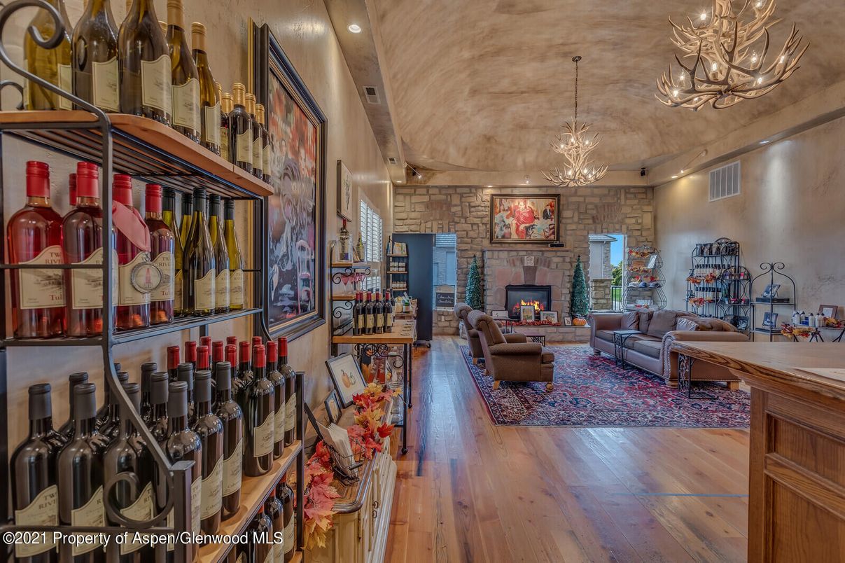 Chandelier, Fireplace, Interior, Living room, Pendant Lights, Recessed Lighting, Stone Walls, Wood Texture Flooring